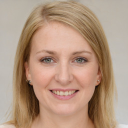 Joyful white young-adult female with medium  brown hair and blue eyes