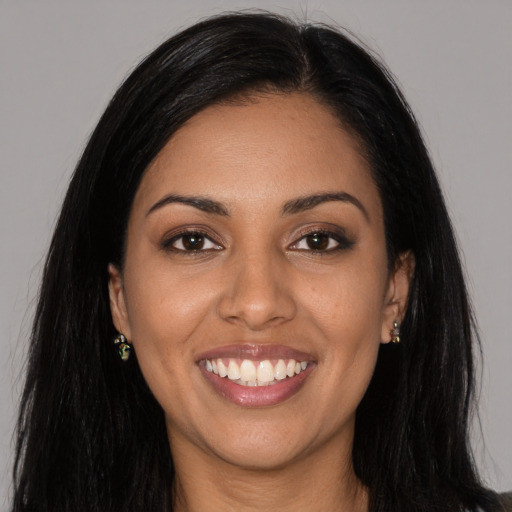 Joyful latino young-adult female with long  black hair and brown eyes