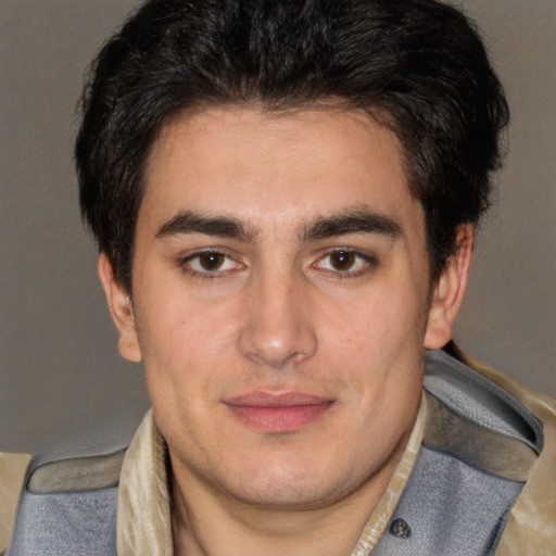 Joyful latino young-adult male with short  brown hair and brown eyes