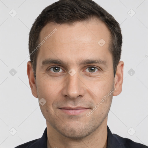 Joyful white adult male with short  brown hair and brown eyes