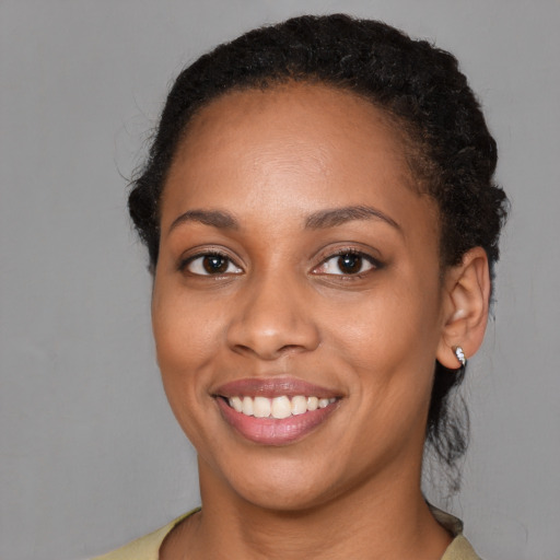 Joyful latino young-adult female with short  black hair and brown eyes