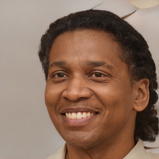 Joyful black adult male with short  brown hair and brown eyes