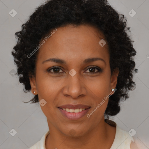 Joyful black adult female with short  brown hair and brown eyes