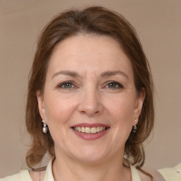 Joyful white adult female with medium  brown hair and brown eyes