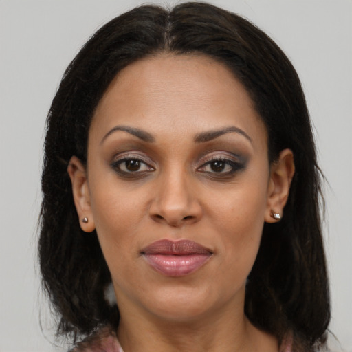 Joyful black young-adult female with medium  brown hair and brown eyes