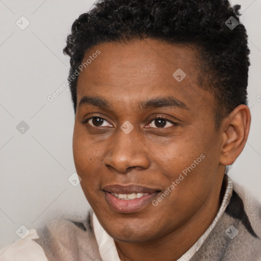 Joyful black young-adult male with short  brown hair and brown eyes