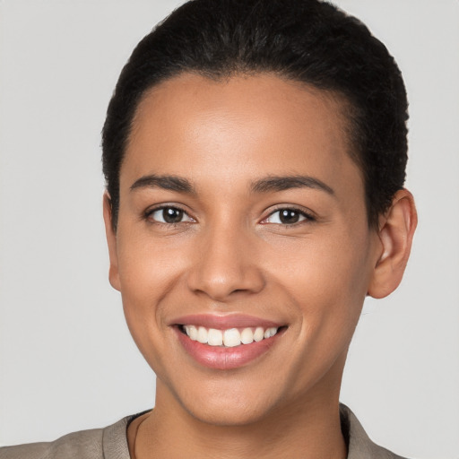 Joyful latino young-adult female with short  brown hair and brown eyes