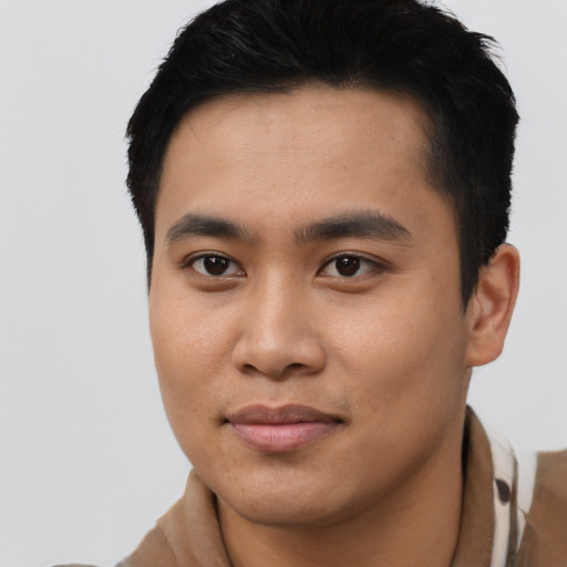 Joyful asian young-adult male with short  black hair and brown eyes