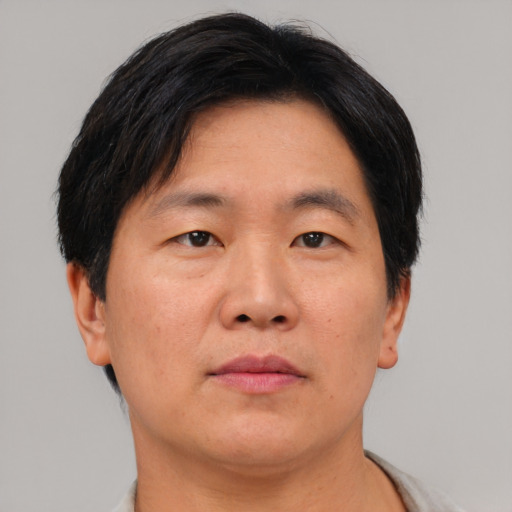 Neutral asian adult male with short  brown hair and brown eyes