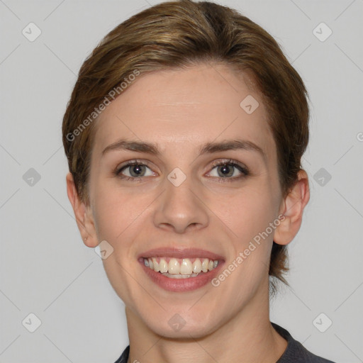 Joyful white young-adult female with medium  brown hair and grey eyes