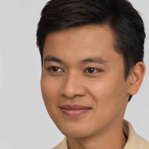 Joyful asian young-adult male with short  brown hair and brown eyes
