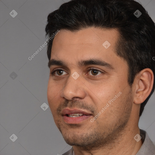 Joyful white young-adult male with short  black hair and brown eyes