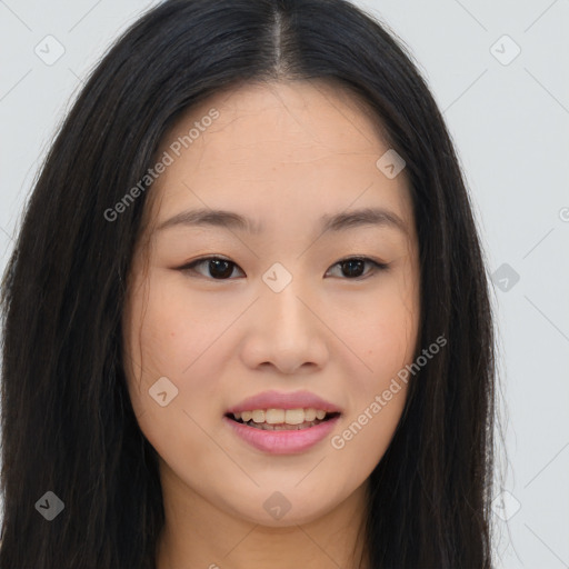 Joyful asian young-adult female with long  brown hair and brown eyes