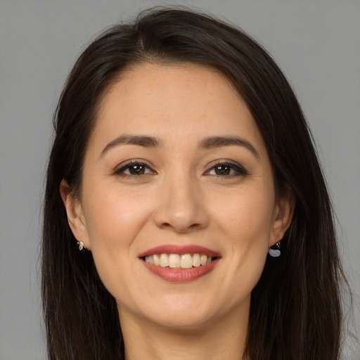 Joyful white young-adult female with long  brown hair and brown eyes