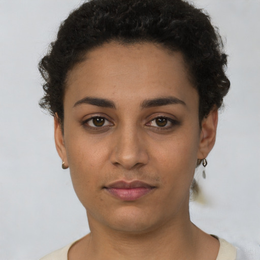 Joyful latino young-adult female with short  brown hair and brown eyes