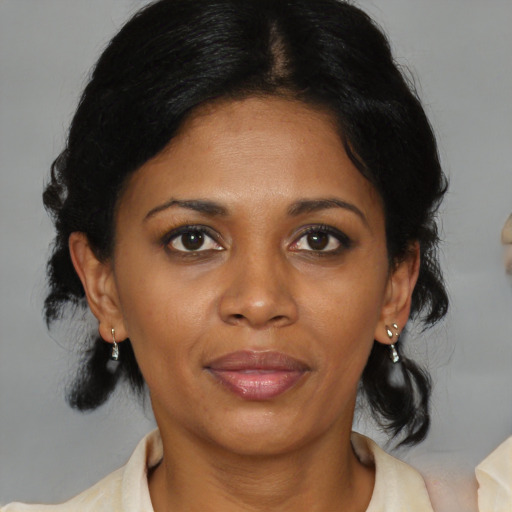 Joyful black adult female with medium  black hair and brown eyes