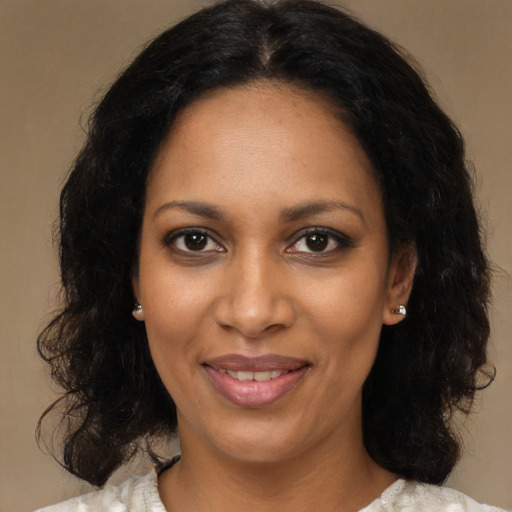 Joyful black young-adult female with medium  brown hair and brown eyes
