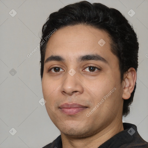 Joyful white young-adult male with short  black hair and brown eyes