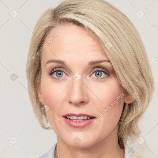 Joyful white adult female with medium  brown hair and blue eyes