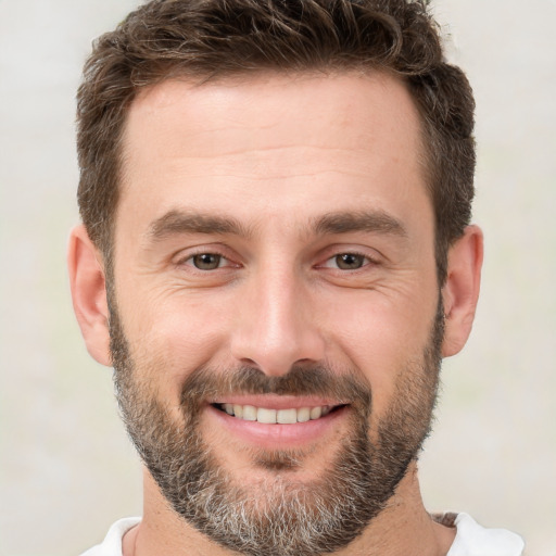 Joyful white adult male with short  brown hair and brown eyes