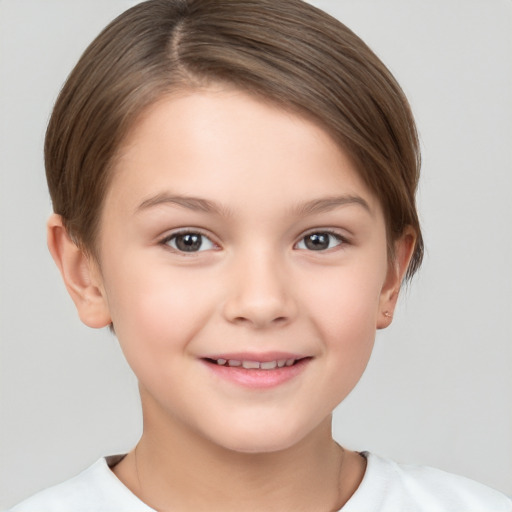 Joyful white child female with short  brown hair and brown eyes