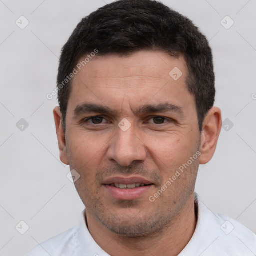 Joyful white adult male with short  black hair and brown eyes