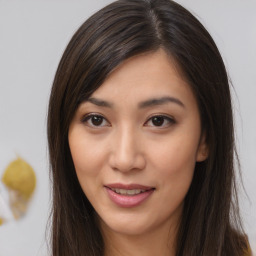 Joyful asian young-adult female with long  brown hair and brown eyes