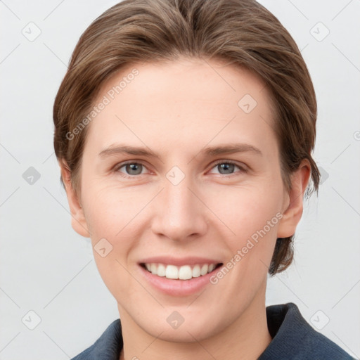 Joyful white young-adult female with short  brown hair and grey eyes