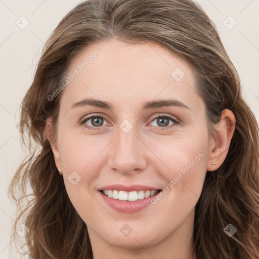 Joyful white young-adult female with long  brown hair and blue eyes