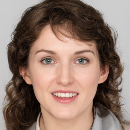 Joyful white young-adult female with medium  brown hair and green eyes