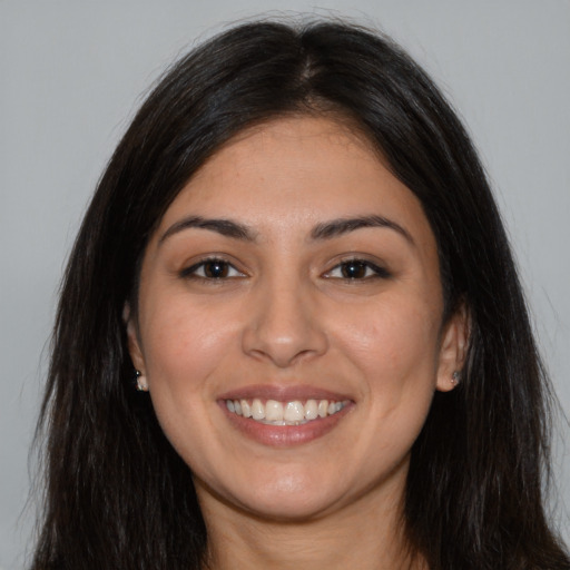 Joyful latino young-adult female with long  brown hair and brown eyes