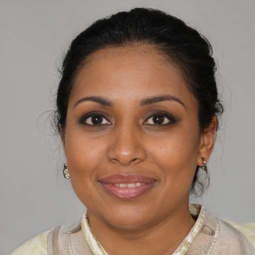 Joyful black young-adult female with medium  brown hair and brown eyes