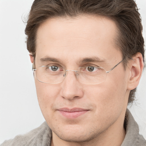 Joyful white adult male with short  brown hair and grey eyes