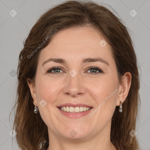 Joyful white adult female with medium  brown hair and grey eyes