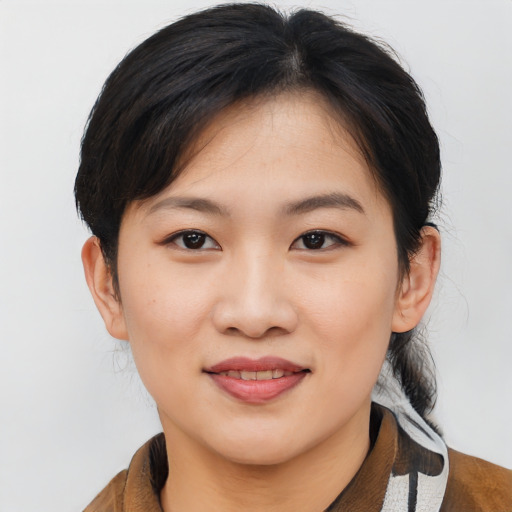 Joyful asian young-adult female with medium  brown hair and brown eyes
