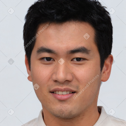 Joyful asian young-adult male with short  black hair and brown eyes