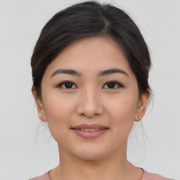 Joyful asian young-adult female with medium  brown hair and brown eyes