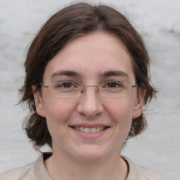 Joyful white adult female with medium  brown hair and brown eyes