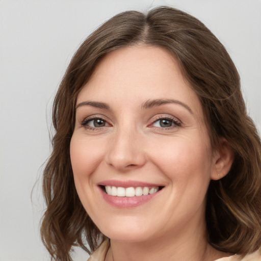 Joyful white young-adult female with long  brown hair and grey eyes