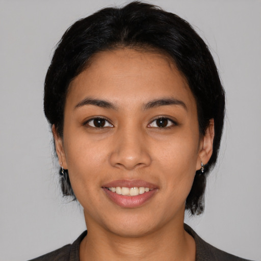 Joyful latino young-adult female with medium  black hair and brown eyes