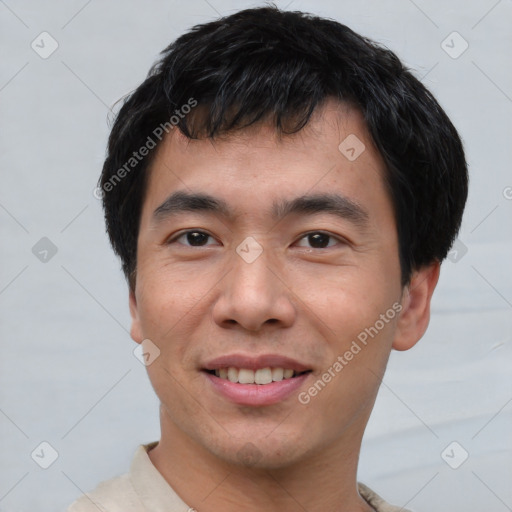 Joyful asian young-adult male with short  black hair and brown eyes