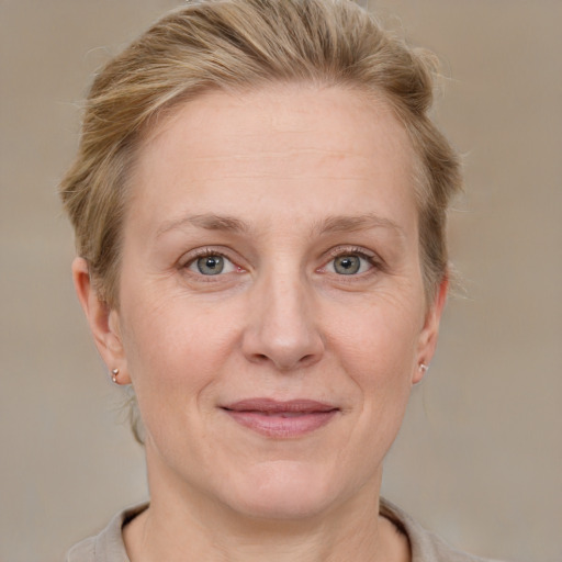 Joyful white adult female with short  brown hair and grey eyes