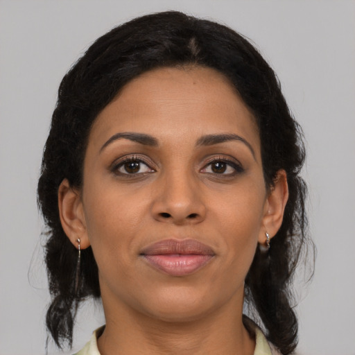 Joyful black young-adult female with medium  brown hair and brown eyes