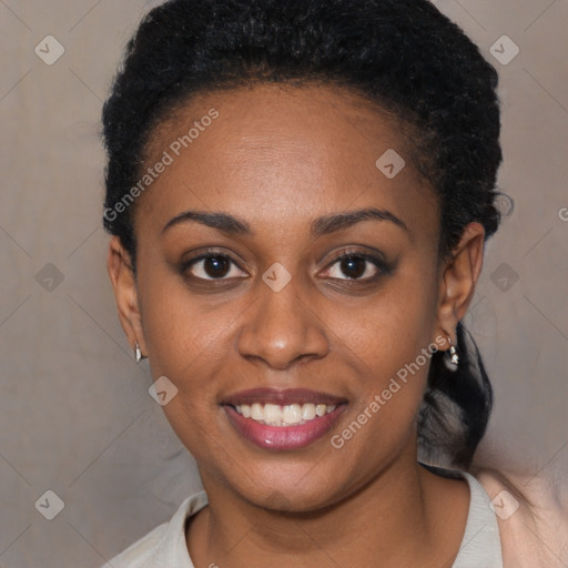 Joyful black young-adult female with short  black hair and brown eyes