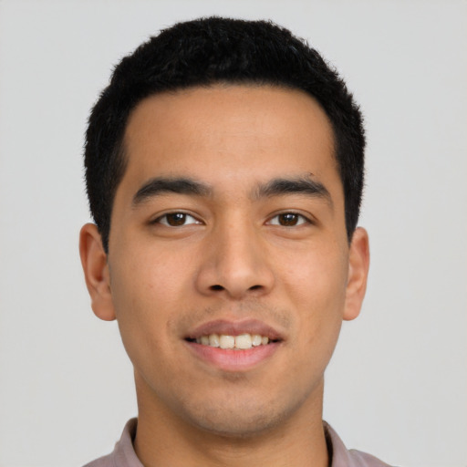 Joyful latino young-adult male with short  black hair and brown eyes
