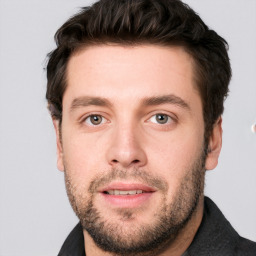 Joyful white adult male with short  brown hair and grey eyes