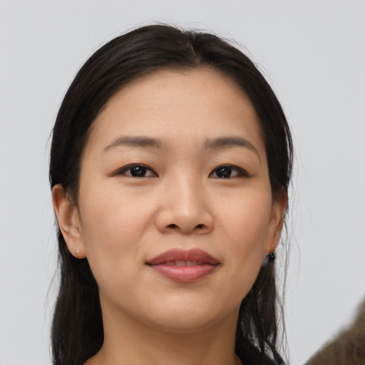 Joyful asian young-adult female with medium  brown hair and brown eyes