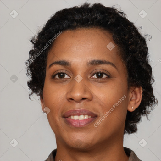 Joyful black young-adult female with short  brown hair and brown eyes