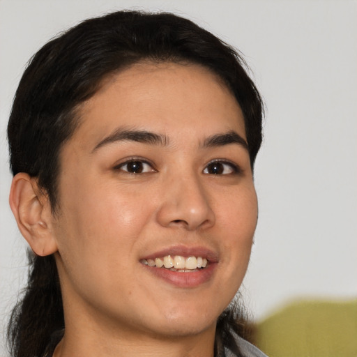 Joyful latino young-adult female with short  brown hair and brown eyes