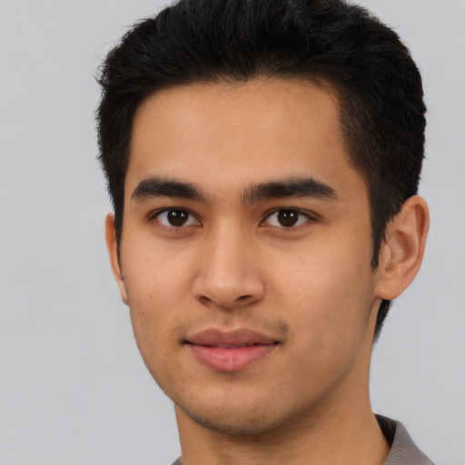 Joyful latino young-adult male with short  brown hair and brown eyes